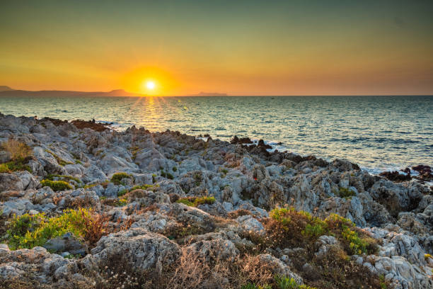 istock Gilded Horizon: A Serene Evening on Rethymno's Rocky Beach at Sunset 1659995167