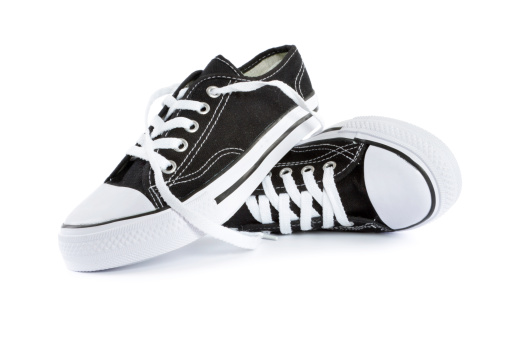 brand new black and white tennis shoes on white background.