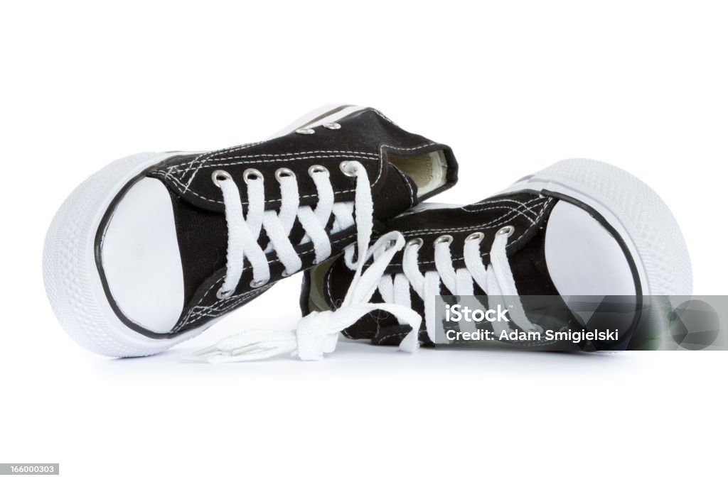 tennis shoes tied, brand new black and white tennis shoes on white background. Tied Up Stock Photo