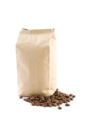 paper bag with coffee beans on white background