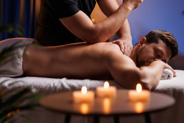 istock Handsome man having restorative back massage in spa salon, enjoying relaxing atmosphere, recharging after work. Masseuse gives therapeutic back massage to a visitor, the concept of healthy lifestyle. 1660009057