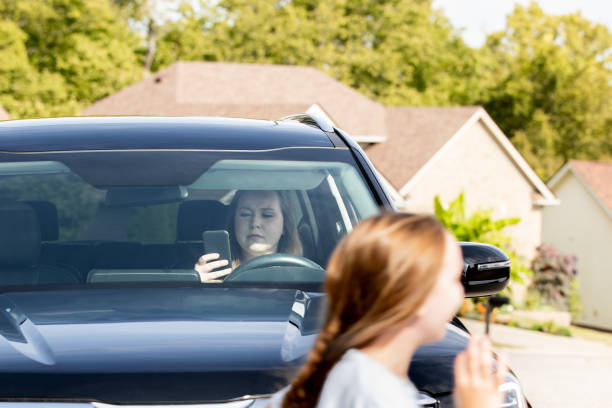 istock Distracted driver is texting and doing her makeup, almost hitting children in the crosswalk 1660013045