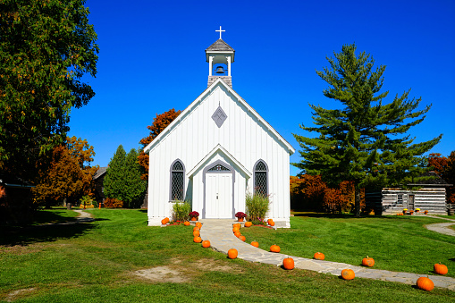 Autumn colorful trees surround little country chapel. This is not a real church, it is very small, but very scenic.