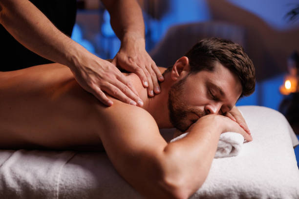 istock Handsome man having restorative back massage in spa salon, enjoying relaxing atmosphere, recharging after work. Masseuse gives therapeutic back massage to a visitor, the concept of healthy lifestyle. 1660023947