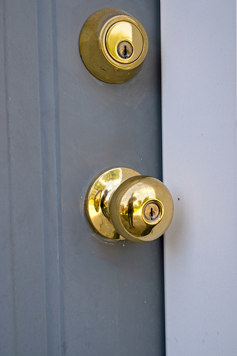 door handle and deadbolt lock on exterior steel home door.