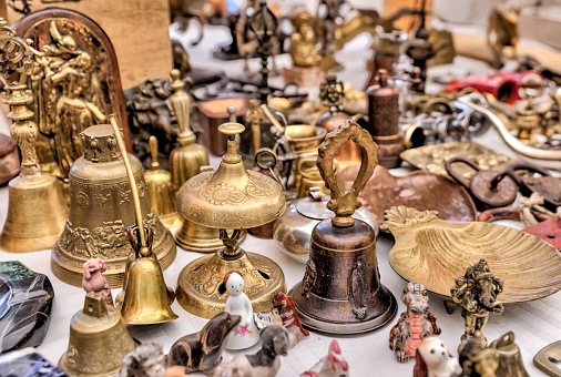 An stall at an open market selling antiques and junk.