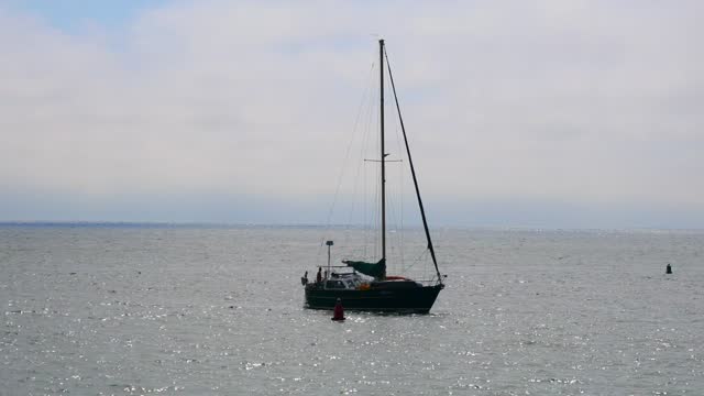 Sailboat traveling across the Pacific Ocean to the coast near Stearns Wharf in Santa Barbara