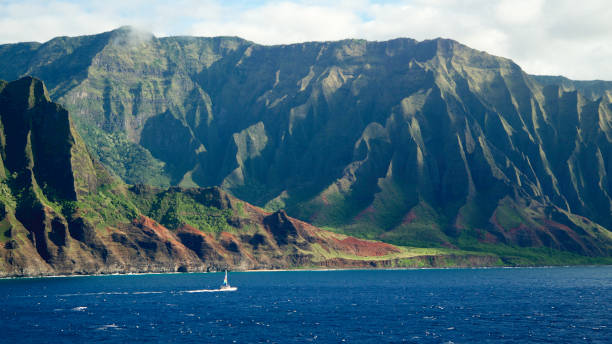 Sailboat crossing the Napali coast, Kauai stock photo