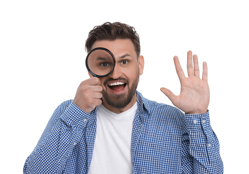 Happy man looking through magnifier on white background