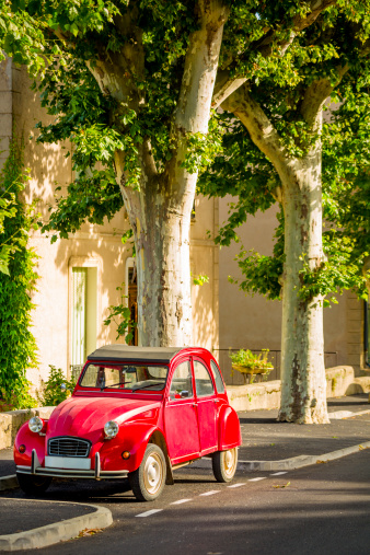 Vintage car parked in town in Provence, France.