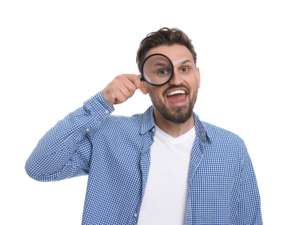 istock Happy man looking through magnifier on white background 1660075934
