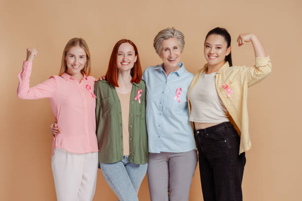 Women wearing pink ribbon celebrate recovery isolated. Breast cancer awareness month strong women wearing pink ribbon celebrate recovery isolated. Breast cancer awareness month brest cancer hope stock pictures, royalty-free photos & images