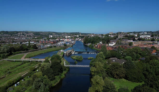 istock Exeter, South Devon, England: DRONE VIEWS: The River Exe, Exeter Ship Canal, Trews Weir and Suspension Bridge, Exeter Quays and the City of Exeter skyline 1660166512