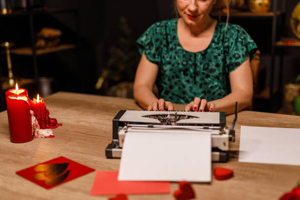 istock Woman typing a romantic love letter on a retro typewriter 1660211601