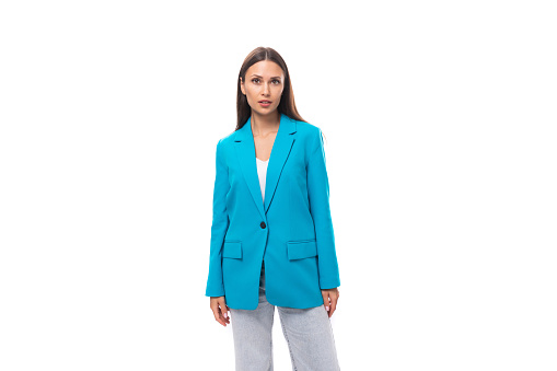 young slender brunette model in a stylish blue designer jacket. fashion concept.