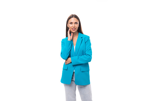 young pretty office worker woman in a blue business jacket on a white background with copy space.