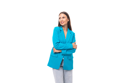 young successful brunette leader woman in a blue jacket on a white background with copy space.