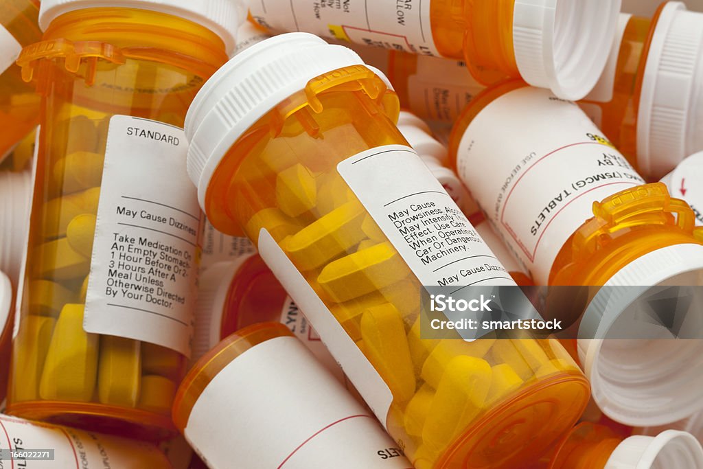 Several Prescription Pill Bottles in a Pile Bottles of prescription medicine in a pile. This collection of pill bottles is symbolic of the many medications senior adults and chronically ill people take. Prescription Medicine Stock Photo