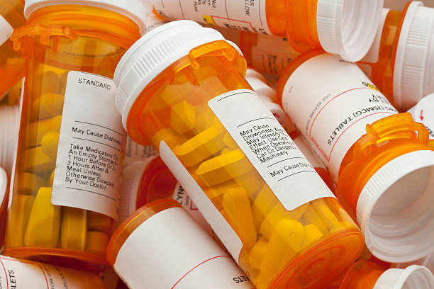 Several Prescription Pill Bottles in a Pile Bottles of prescription medicine in a pile. This collection of pill bottles is symbolic of the many medications senior adults and chronically ill people take. prescription medicine stock pictures, royalty-free photos & images