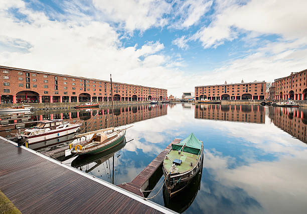 Albert Dock Reflections The Albert Dock in Liverpool, England.  The dock was opened in 1846 and is a major tourist location, with attractions including the Tate Liverpool, the Merseyside Maritime Museum and the the Beatles Story. floating platform stock pictures, royalty-free photos & images