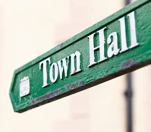 Town Hall Arrow Sign Close-up of a traditional, worn sign showing the direction to the town hall. town hall government building photos stock pictures, royalty-free photos & images