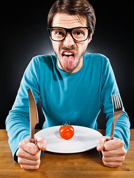 istock Skinny man, hate vegetable, tomato, humorously, poor nutrition 166025422