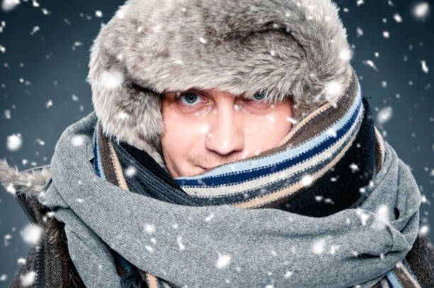 istock Man tightly wrapped in winter clothes, shawl, fur cap 166025456