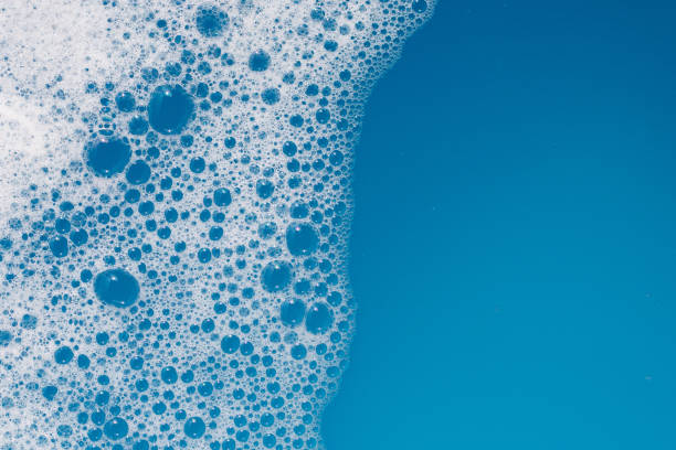 istock Detergent foam bubble on water. Blue background, Soap sud 1660258240