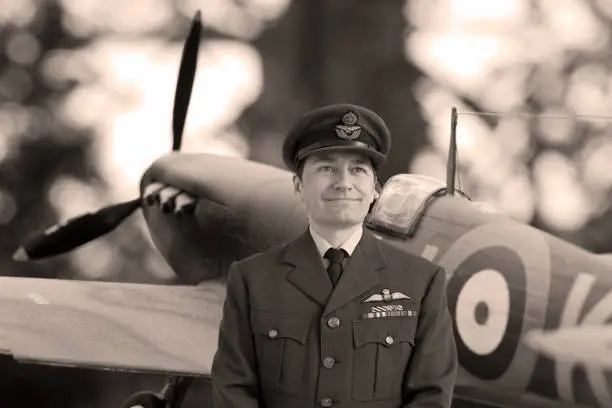 WWII Pilot in Squadron Leader Officers Uniform standing in front of a Spitfire Aircraft