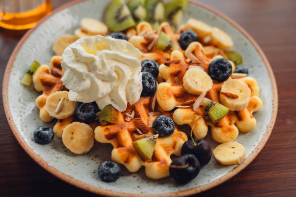 istock Waffles with mixed fruit, cream topping and honey 1660279329
