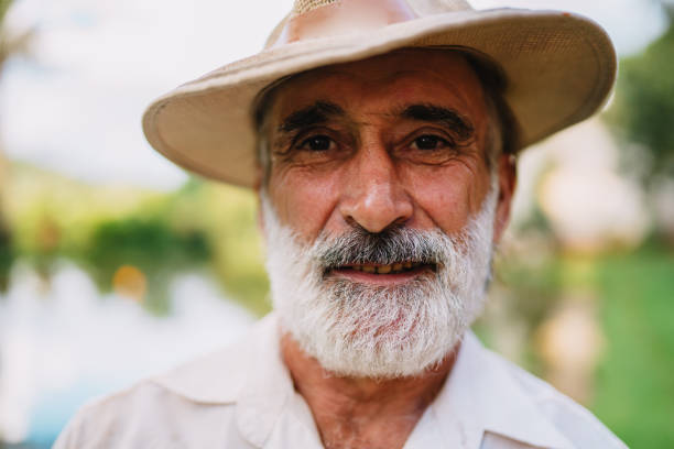 Farmer working on farm. Elderly Brazilian man looking at camera.