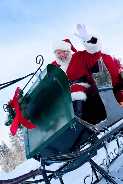 istock Cheerful Santa Claus Waving from Sleigh in Snow, Copy Space 166029606