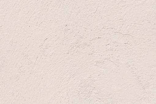 An old plaster cement wall, beige abstract background. Concrete grunge texture