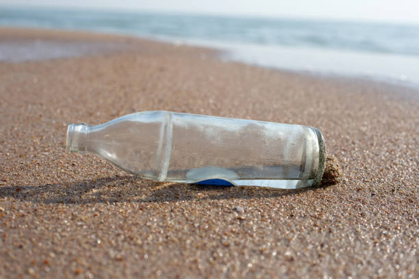 istock Glass bottle on the beach 1660321851