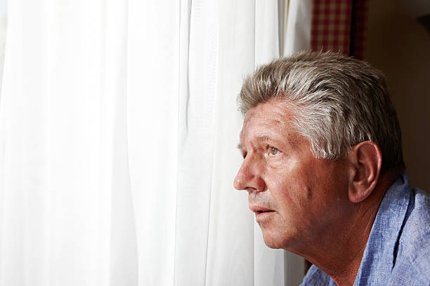 istock Nosy mature man at the window 166034472