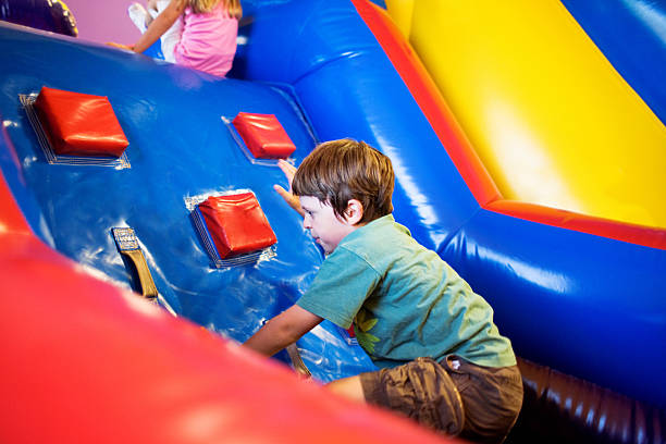 Inflatable Playground Boy having fun on inflatable playground. mm1 stock pictures, royalty-free photos & images