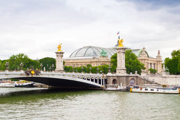 Pont Alexandre III with Grand Palais in background, Paris. The bridge was built in 1896 and decorated with ornate Art Nouveau lamps and sculptures. It is the most extravagant bridge in Paris. 