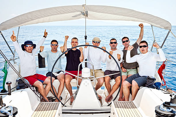 istock Happy sailing crew on sailboat 166036978