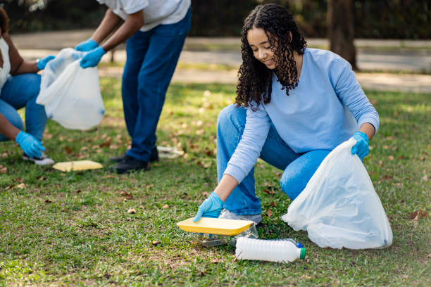 istock People volunteering picking up trash in the public park 1660387052