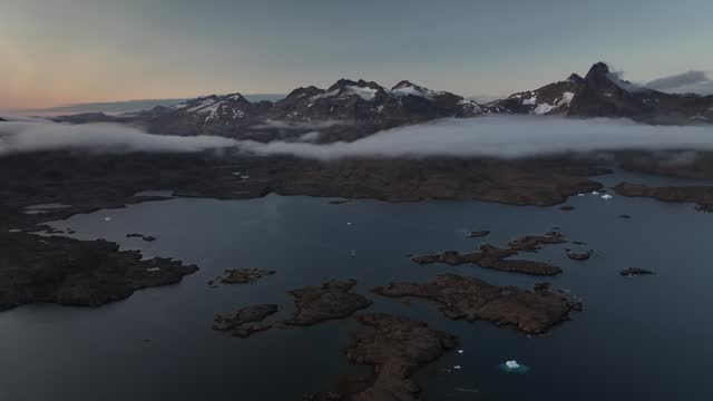 aerial view of arctic ocean fjord with foggy sky