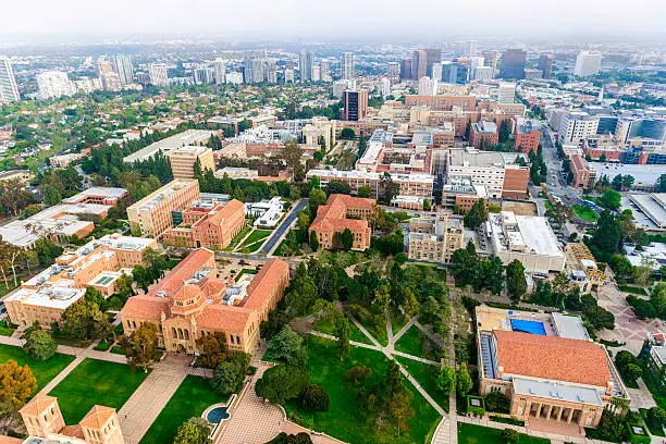 aerial view of campus of University of California in Los Angeles, with smoggy cityscape of  Los Angeles, California in the background