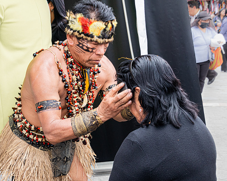 Cuenca, Ecuador - March 25, 2023: Craft Fair of the Province of Pastaza in Cuenca. A shaman of Amazonian Quechua indigenous nationality conducts an ancient ceremony of purification and healing.