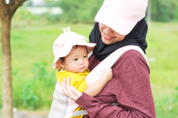 istock Smiling Mother and Daughter under a Tree 1660438982
