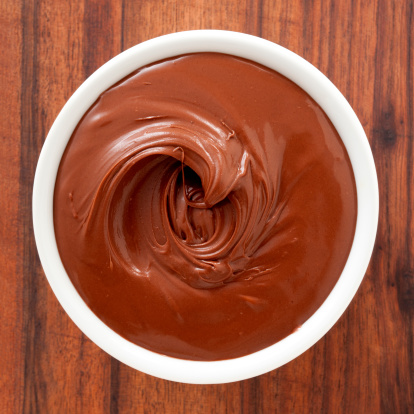 Top view of white bowl full of chocolate spread