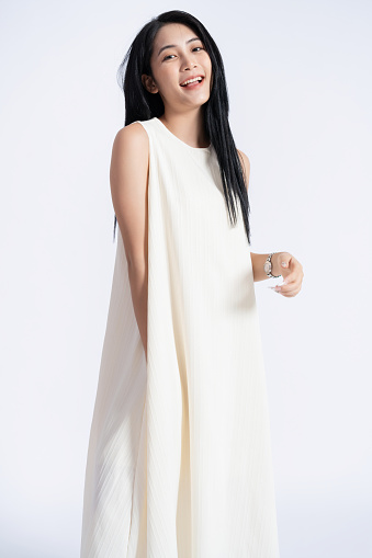 Photo of young Asian girl wearing dress on background