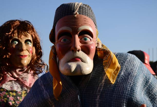 Mittenwald, Germany - February 16: participants of a parade with traditional disguise with large wooden masks and historic costumes called 'maschkera' on February 16, 2023 in Mittenwald