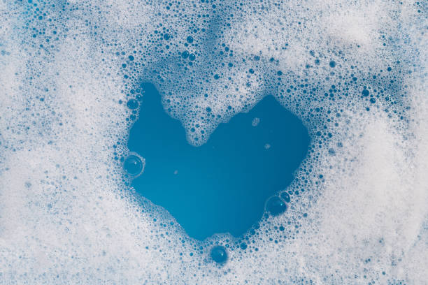 istock Detergent foam bubble on water. Blue background, Soap sud 1660469446