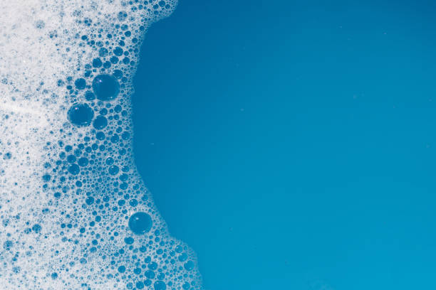 istock Detergent foam bubble on water. Blue background, Soap sud 1660469847