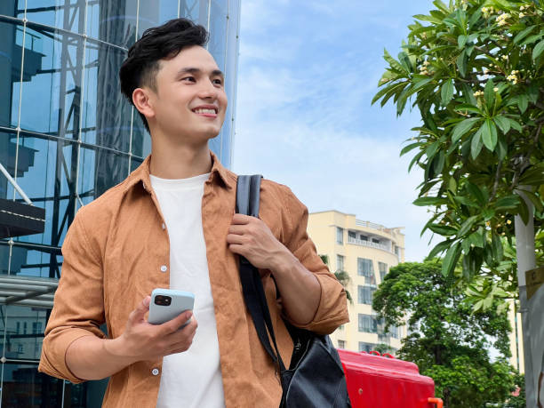 istock Portrait of young Asian man outside 1660470010