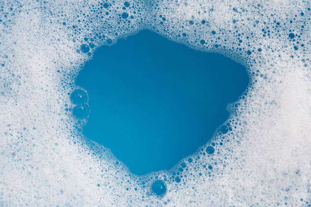 istock Detergent foam bubble on water. Blue background, Soap sud 1660485253